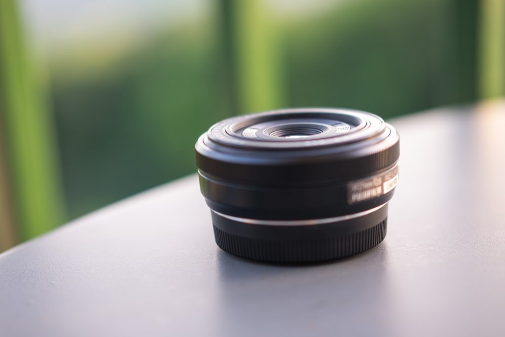 selective focus photography of round black lens on gray surface